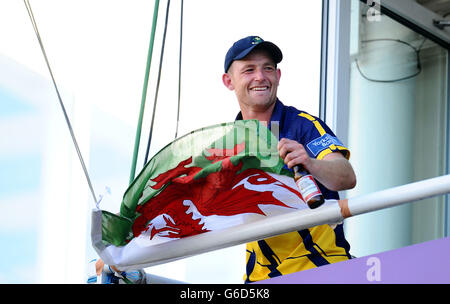 Graham Wagg di Glamorgan festeggia sulla balaconia della squadra con una bandiera gallese dopo la partita semi finale di Clydesdale Bank Pro40 all'Ageas Bowl, Southampton. Foto Stock