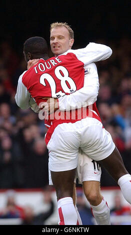 Dennis Bergkamp dell'Arsenal celebra il suo obiettivo con il compagno di squadra Kolo Toure durante la sua partita Barclaycard Premiership ad Highbury, nel nord di Londra. Foto Stock