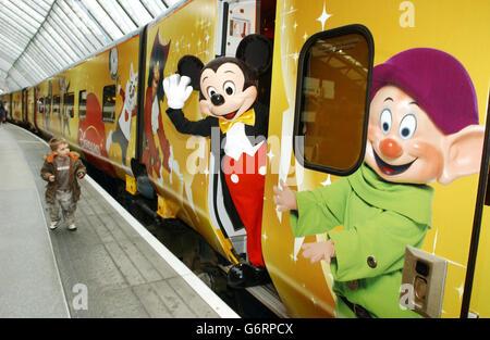 Mickey mouse' con Yann Caillere (a sinistra), Presidente e COO di Disneyland Resort Paris e Paul Charles, Direttore delle Comunicazioni di Eurostar, al nosecone di un treno Eurostar in livrea con personaggi Disney, prima di partire da Waterloo al resort. Foto Stock