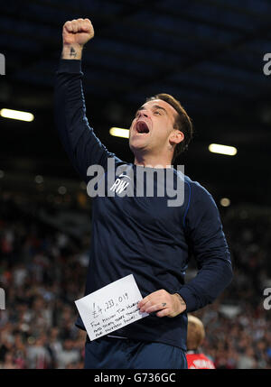 Robbie Williams in Inghilterra festeggia con la quantità di denaro raccolta dalla partita di beneficenza Soccer Aid a Old Trafford, Manchester. Foto Stock