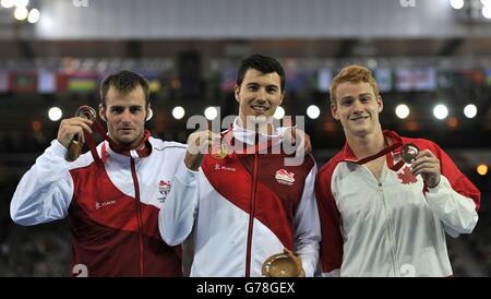 Steve Lewis in Inghilterra con la sua medaglia d'oro (al centro) accanto alla medaglia d'argento Luke Cutts dall'Inghilterra e al barbiere canadese Shawnacy con la sua medaglia di bronzo per il Men's Pole Vault durante i Giochi del Commonwealth 2014 a Glasgow. Foto Stock