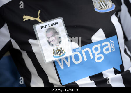 Un distintivo su una maglietta da club replica come omaggio al sostenitore della Newcastle United Liam Sweeney che ha perso la vita nel disastro della Malaysia Airlines MH17, fuori terra prima della partita della Barclays Premier League a St James' Park, Newcastle. Foto Stock