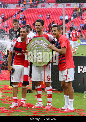 I Santi Cazorla di Arsenal, Mikel Arteta e Alexis Sanchez (da sinistra a destra) celebrano la vittoria sulla città di Manchester nella partita Community Shield al Wembley Stadium di Londra. Foto Stock