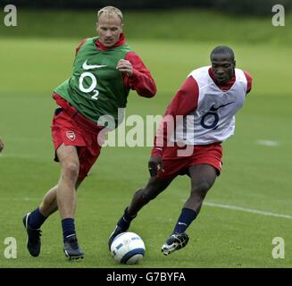 Dennis Bergkamp di Arsenal (a sinistra) contesta la palla con Lauren, durante una sessione di allenamento al London Colney vicino a St Albans, prima di giocare a PSV Eindhoven in Champions League a Highbury domani. Foto Stock