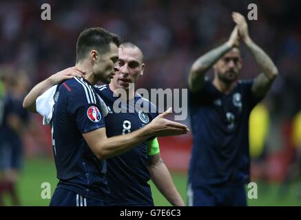 Scott Brown (al centro) della Scozia ha discusso con il compagno di squadra Russell Martin (a sinistra) alla fine della partita durante la partita di qualificazione UEFA Euro 2016 allo Stadio Nazionale di Varsavia, Varsavia. Foto Stock