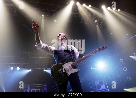 Il chitarrista Francis Rossi del gruppo rock Status Quo sul palco, durante il loro concerto alla Wembley Arena di Londra. Foto Stock