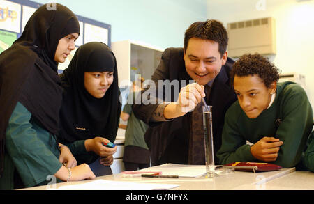 Stephen Twigg, ministro degli Standard scolastici, unisce gli studenti in un esperimento per misurare la velocità terminale, utilizzando un cordone di cellule styro in acqua, presso la scuola secondaria di Oaklands. Da sinistra, i 11 allievi sono Ayesha Khatun, 15, Rumena Begum, 15 e Ashley Regis, 16. Foto Stock