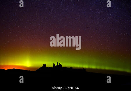 L'aurora boreale, o l'aurora boreale come sono comunemente conosciuti al castello di Dunstanburgh in Northumberland. Foto Stock