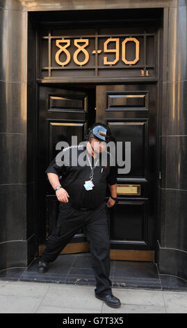 Una guardia di sicurezza passi dalla Hatton Garden Safe Deposit società, a Londra, come i ladri che utilizzano attrezzature pesanti di taglio sono rotto in diverse cassette di sicurezza in una volta presso la società di deposito, il raid è pensato per essere accaduto nel corso del week-end di Pasqua banca vacanza. Foto Stock