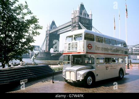 Uno dei 25 autobus a due piani argentati, dipinto appositamente per segnare il Giubileo d'Argento della Regina, si trova di fronte al Tower Bridge. Foto Stock