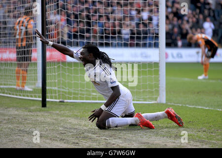 Il Bafetimbi Gomis di Swansea City festeggia il terzo gol del suo fianco durante la partita della Barclays Premier League al Liberty Stadium di Swansea. Foto Stock