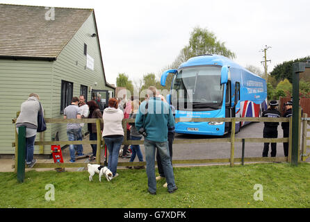 I membri del pubblico si trovano fuori dalla sala del villaggio di Norton sub Hamdon mentre attendono l'arrivo del primo ministro David Cameron sull'autobus del partito conservatore durante una visita della campagna elettorale generale nel Somerset. Foto Stock
