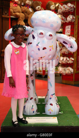 Emmanuella, con Shaun the Sheep durante un evento organizzato da Nutricia per sensibilizzare l'opinione pubblica sulla nutrizione medica presso il negozio di giocattoli Hamleys in London Regent Street. Foto Stock