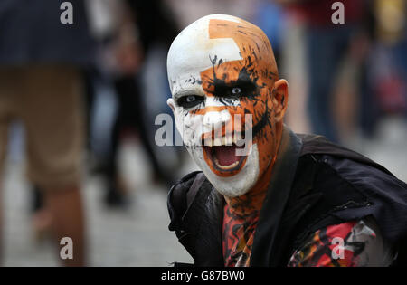 Durante l'Edinburgh Fringe Festival, un esecutore suona alla folla sul Royal Mile. Foto Stock