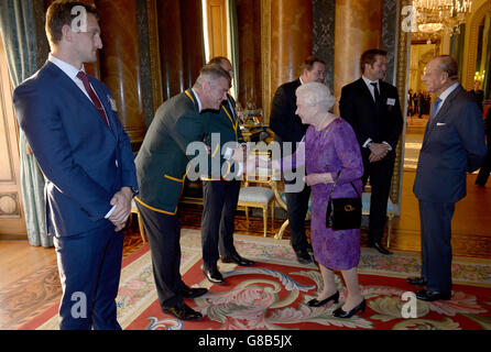 La regina Elisabetta II incontra il capo allenatore del Rugby Union del Sud Africa, Heyneke Meyer, presso un ricevimento a Buckingham Palace, per dare il benvenuto alle star della Coppa del mondo di Rugby. Foto Stock