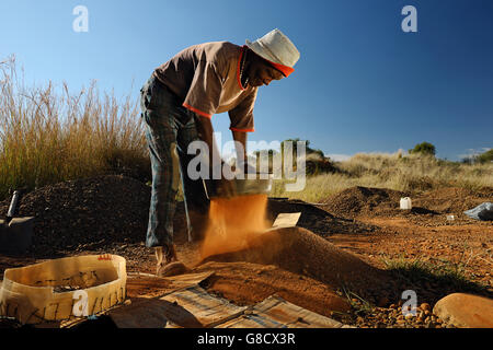 Diamond miner piccolo escavatore vagliatura, Sud Africa. Foto Stock
