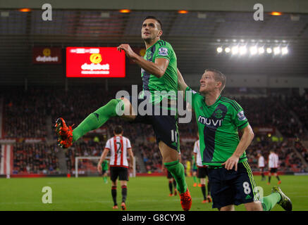 Il Dusan Tadic di Southampton celebra il suo obiettivo di penalità con Steven Davis durante la partita Barclays Premier League allo Stadium of Light di Sunderland. Foto Stock