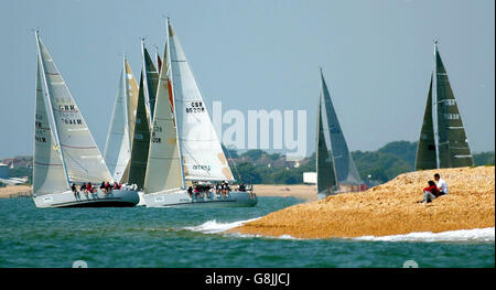 Gli yacht di classe tre si allontanano dalla spiaggia nel Solent orientale di Alverstoke, Hampshire, durante le corse nella regata annuale della settimana dei Cowes, la più grande regata velica del mondo. Foto Stock