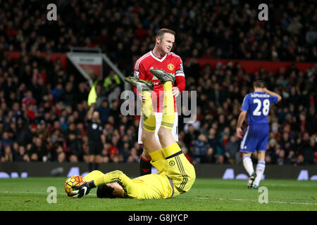 Wayne Rooney di Manchester United (a destra), il portiere del Chelsea Thibaut Courtois tiene sul pallone dopo aver fatto un salvataggio durante la partita della Barclays Premier League a Old Trafford, Manchester. Foto Stock