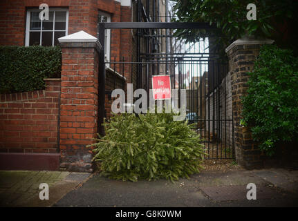 Un albero di Natale scartato è visto a sinistra sulle strade di Battersea, Londra. Foto Stock