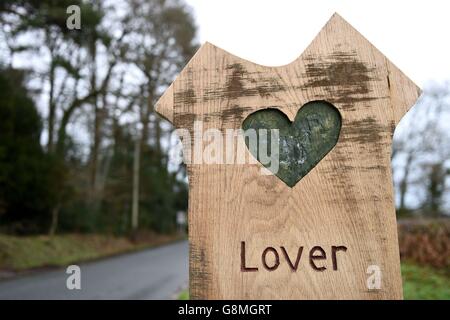 Vista generale di un segno per il villaggio amante nel Wiltshire, come i residenti hanno inviato un appello di San Valentino per l'aiuto nella loro offerta di riportare la vita nella loro casa rurale. Foto Stock