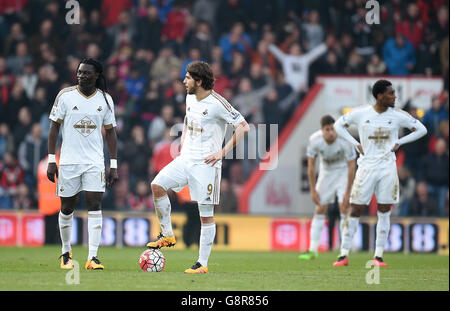 Alberto Paloschi di Swansea City (al centro) e il Baafetimbi Gomis di Swansea City (a sinistra) si sfidano dopo aver visto il loro lato concedere un terzo obiettivo della partita durante la partita Barclays Premier League al Vitality Stadium di Bournemouth. Foto Stock