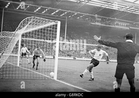 Roger Hunt inglese (seconda r) tocca la palla in rete per segnare il traguardo di apertura, guardato dal compagno di squadra Jack Charlton (l), dal portiere francese Marcel Aubour (seconda l) e dall'arbitro Arturo yamasaki (r) Foto Stock