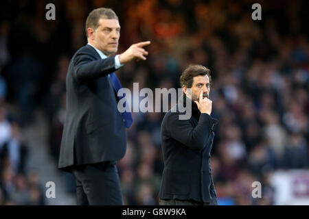 Il manager di Watford Quique Sanchez Flores (a destra) graffia il naso e. West Ham United manager Slaven Bilic (a sinistra) gesti sul linea di contatto Foto Stock