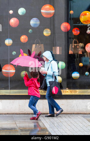 Manchester, Regno Unito. 1 Luglio, 2016. Regno Unito: atmosferiche torrenziali acquazzoni pesanti di pioggia immergere gli amanti dello shopping nel centro della città di Manchester. Le perturbazioni atmosferiche in tutto il nord-ovest dell'Inghilterra catturato gli acquirenti di sorpresa con pesanti rigurgiti di pioggia questo pomeriggio. Alcuni sono stati preparati ma altri utilizzano tecniche alternative per mettersi al riparo. Credito: Cernan Elias/Alamy Live News Foto Stock