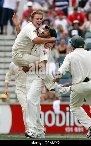 L'australiano Shane Warne (a sinistra) festeggia con Andrew Symonds (al centro) dopo aver preso il wicket finale del britannico Monty Panesar per vincere il quinto giorno del terzo Test match al WACA, Perth, Australia. Foto Stock