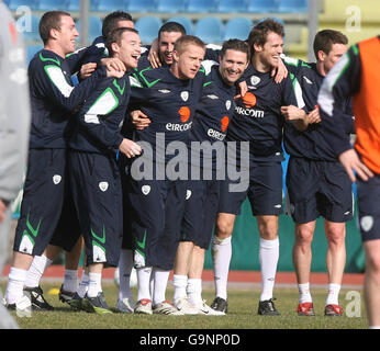 Robbie Keane della Repubblica d'Irlanda (centro a destra) e Damien Duff (centro a sinistra) si mettono in posa con i compagni di squadra durante una sessione di allenamento allo Stadio di Serravalle di San Marino. Foto Stock