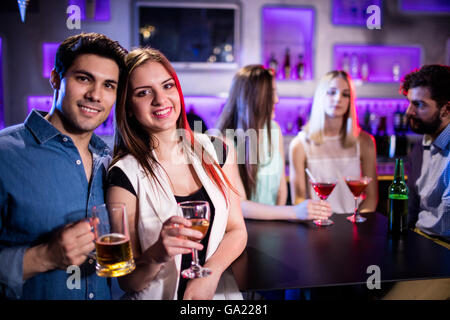 Sorridendo gli amici con un bicchiere di vino e di birra in bar Foto Stock