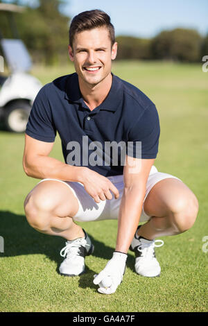 Ritratto di uomo posizionando la pallina da golf sul raccordo a T Foto Stock