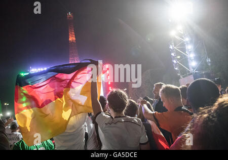 Parigi, Frabce, 2 luglio, 2016. Una folla di tifosi di guardare la trasmissione in diretta del quarto di finale di partita tra Germania e Italia (sede Bordeaux) davanti alla Torre Eiffel a Parigi, Francia 02 luglio 2016. Il gioco è presentato su un 432 metro quadrato sullo schermo. La Germania ha vinto contro Italia con 6:5 Punteggio ottenuto da sanzioni. Credito: dpa picture alliance/Alamy Live News Foto Stock