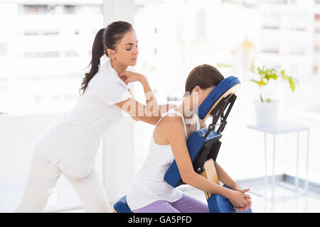 Massaggiatrice dando massaggio alla schiena per donna Foto Stock