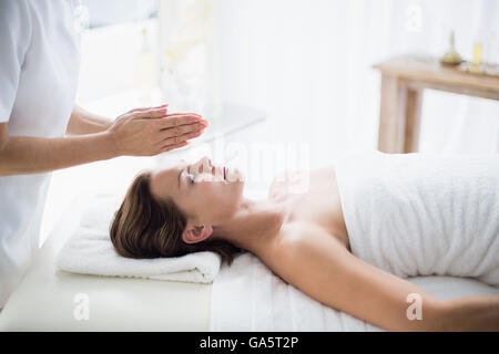 Sezione mediana del terapista esegue reiki sulla donna Foto Stock