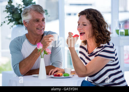 Donna con uomo a mangiare cibo Foto Stock