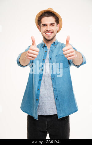 Allegro giovane uomo che mostra pollice in alto isolato su sfondo bianco Foto Stock