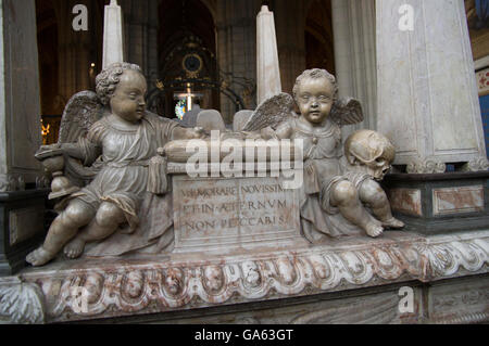 Una tomba scolpita con due putti, una holding di una clessidra e l'altra, un cranio. Iscrizione in latino Foto Stock