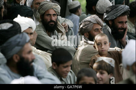 Uomini afghani arrivano a uno Shura - un incontro tra anziani di villaggio e rappresentanti degli eserciti afghani e britannici - nella provincia di Helmand, Afghanistan meridionale. Foto Stock