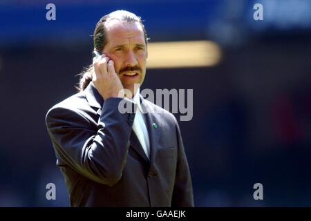 David Seaman di Arsenal parla sul suo cellulare dopo essere stato detto avvierà il gioco Foto Stock