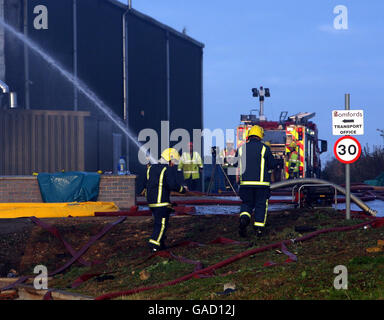 I vigili del fuoco combattono un fuoco mentre il fuoco brucia in un magazzino in una proprietà industriale ad Atherstone su Stour, Warwickshire. Foto Stock