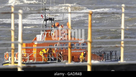 L'equipaggio di Whitby Lifeboat torna dopo aver salvato l'equipaggio di una piccola barca che affondava oggi in acque difficili fuori Whitby Harbour. Foto Stock