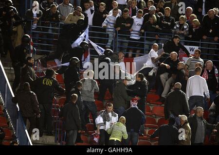 Calcio - Coppa UEFA - Round of 32 - Athletico Madrid / Bolton Wanderers - Stadio Vicente Calderon. La polizia di sommosse si sposta sui fan di Bolton Wanderers nelle tribune verso la fine del gioco. Foto Stock