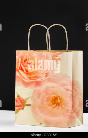 Vuoto riciclabile carta marrone shopping bag con motivo floreale sovrapposta digitalmente, e carta ritorta maniglie. Foto Stock