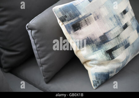 In prossimità di una luce blu cuscino su un divano grigio Foto Stock