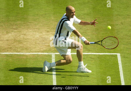 Tennis - Wimbledon 2003 - terzo turno maschile - Andre Agassi / Younes El Aynaoui. Andre Agassi ritorna a Younes El Aynaoui Foto Stock
