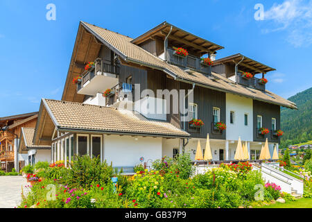 Tradizionale casa alpina in un villaggio sulle rive del lago Weissensee in estate, Austria Foto Stock