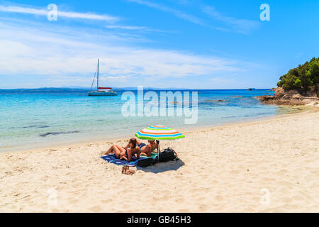 Unidentified paio di persone a prendere il sole sulla sabbia bella grande spiaggia di Sperone, Corsica, Francia Foto Stock