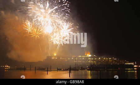 I fuochi d'artificio esplodono nel cielo mentre la nave Cunard da 70,000 tonnellate, la QE2, lascia le banchine di Southampton per l'ultima volta. Foto Stock